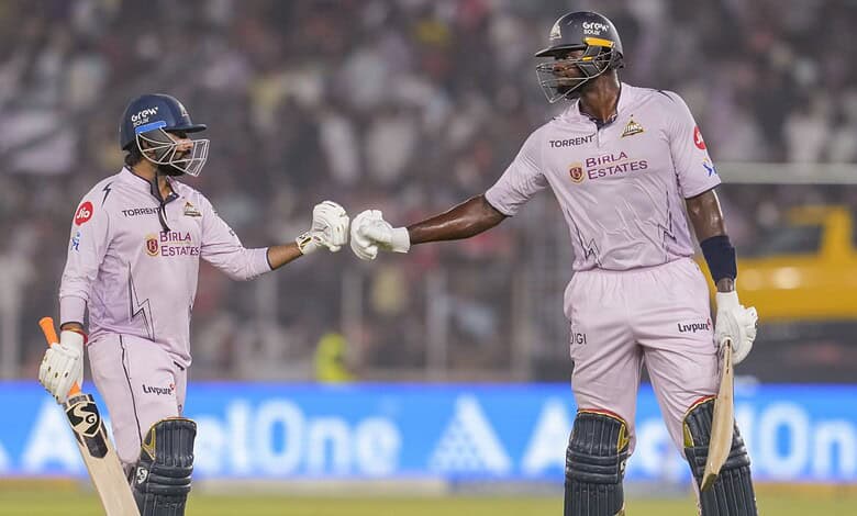 Gujarat Titans' Rahul Tewatia, left, and Jason Holder interact during an Indian Premier League (IPL) 2026 T20 cricket match between Gujarat Titans and Sunrisers Hyderbad, in Ahmedabad, Gujarat, Tuesday, May 12, 2026. (PTI Photo/Shahbaz Khan)
