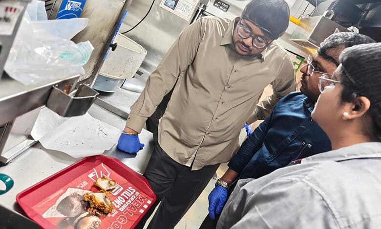 Food safety inspector examining oil quality at KFC outlet in Kondapur, Hyderabad.