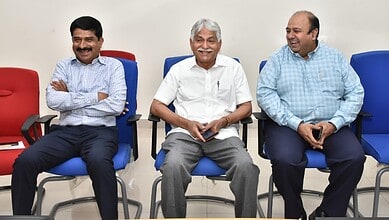Experienced professionals engaging in a lively discussion during a corporate meeting at The Siasat Daily.