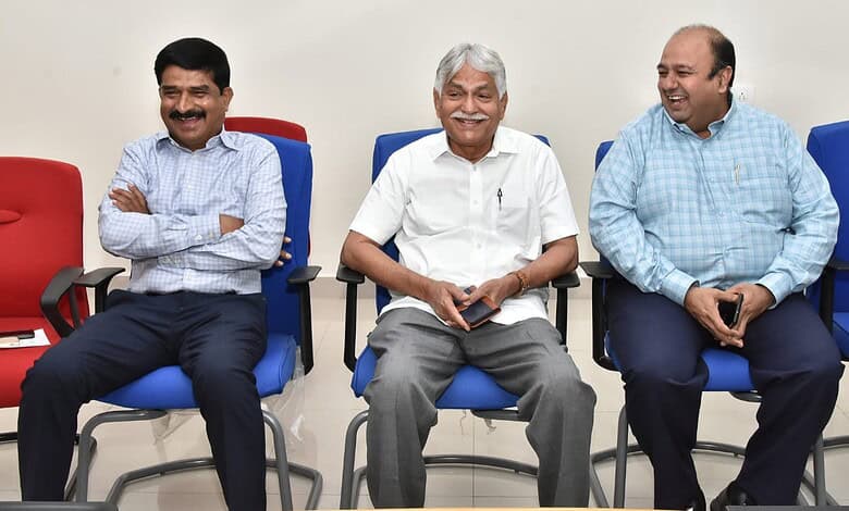 Experienced professionals engaging in a lively discussion during a corporate meeting at The Siasat Daily.