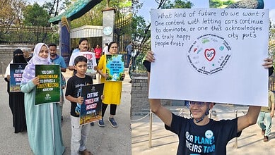 The image shows people protesting at KBR Park against the felling of trees for the construction of flyovers and underpasses around the park on Thursday, May 7, 2026.