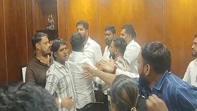 Group of men in a heated discussion inside a wooden-paneled room, some gesturing passionately.