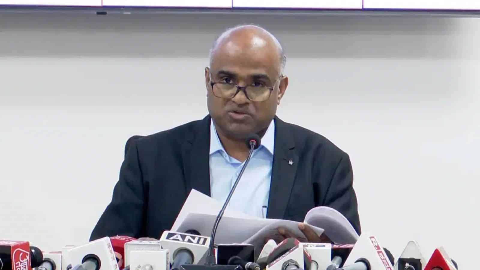 Senior male journalist reading notes during press conference at The Siasat Daily event.