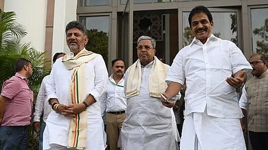 Celebration of political leaders outdoors with smiles, traditional attire, and a welcoming atmosphere.