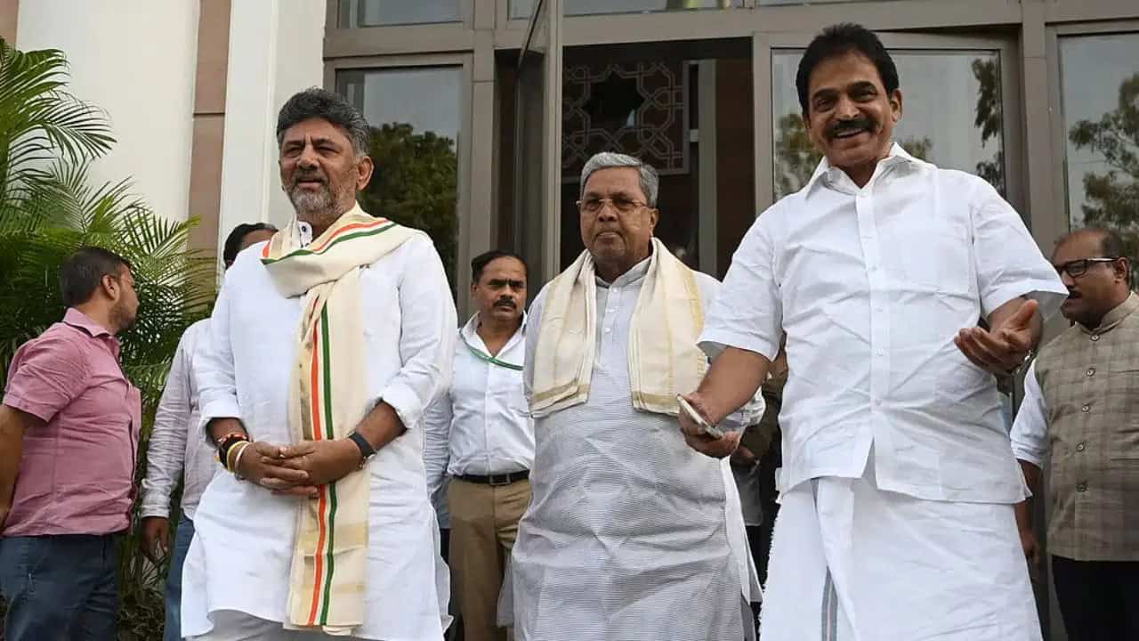 Celebration of political leaders outdoors with smiles, traditional attire, and a welcoming atmosphere.