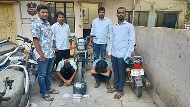 Youth group with motorcycles in an urban setting, India.