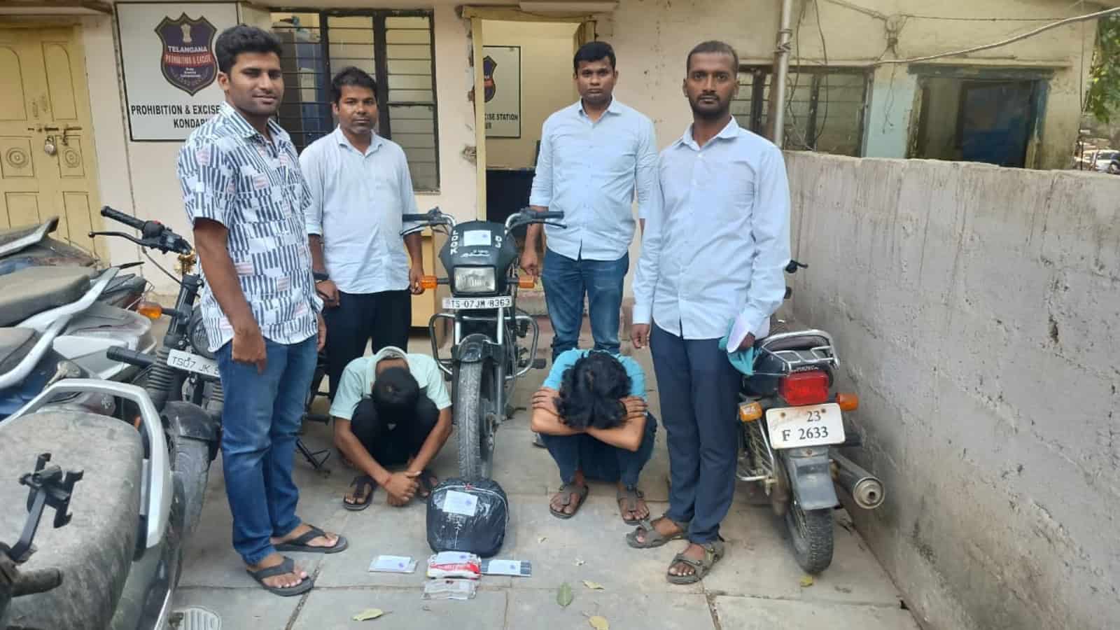 Youth group with motorcycles in an urban setting, India.
