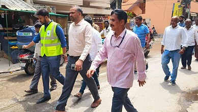 Officials inspecting waterlogging in Jubilee Hills area, led by MLA and GHMC chiefs, to address flooding.
