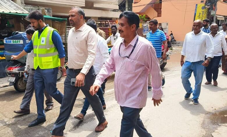 Officials inspecting waterlogging in Jubilee Hills area, led by MLA and GHMC chiefs, to address flooding.