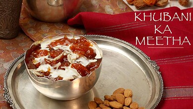 A traditional Indian dessert served in a metal bowl with almonds and sweet syrup, highlighting festive an.