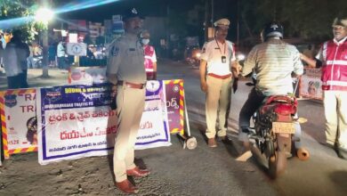 Police officers managing traffic at night with warning signs in the background, ensuring safety and order.