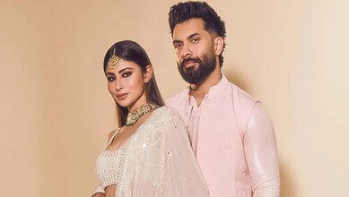 Elegant Indian couple in traditional attire, celebrating cultural festival, showcasing vibrant clothing a.