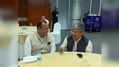 Officials discussing Hyderabad-Vijayawada Regional Ring Road project at a conference.