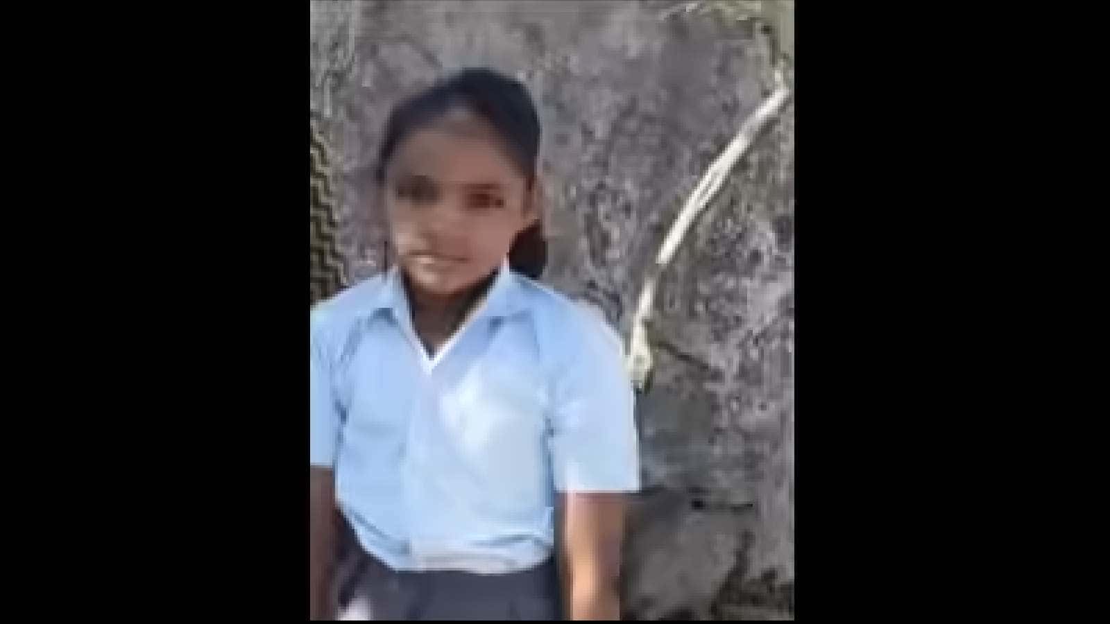 Young girl in school uniform sitting near a tree, showing the impact of stray dog attack in Rajasthan.