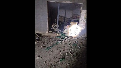 Policemen injured in militant attack in KPK, Pakistan, with debris and damage visible in the scene.