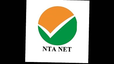 The NTA NET logo featuring a checkmark within a circular design in orange, green, and white colours.