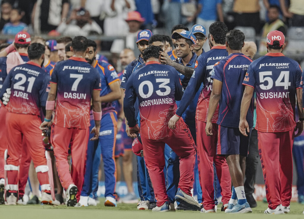 Indian cricket team players celebrating on the field after a match at the stadium.