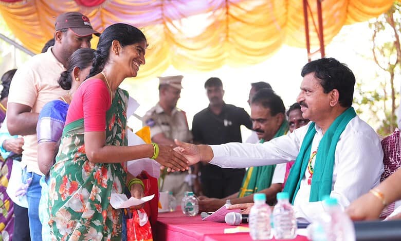 Official greets Telangana minister at housing event.