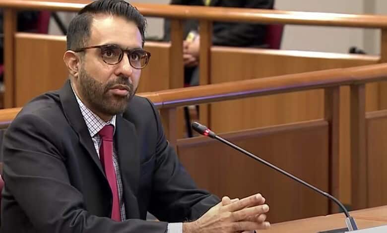 Singapore politician of Indian descent during parliamentary session, facing criticism for dishonesty.