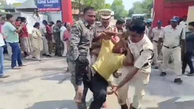 Protest scene with TGSRTC workers and police officers during demonstration about faulty breath analyser m.