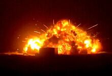 Explosion at night with bright flames and smoke, creating a dramatic scene with fiery destruction and int.