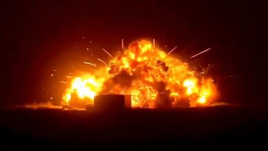 Explosion at night with bright flames and smoke, creating a dramatic scene with fiery destruction and int.