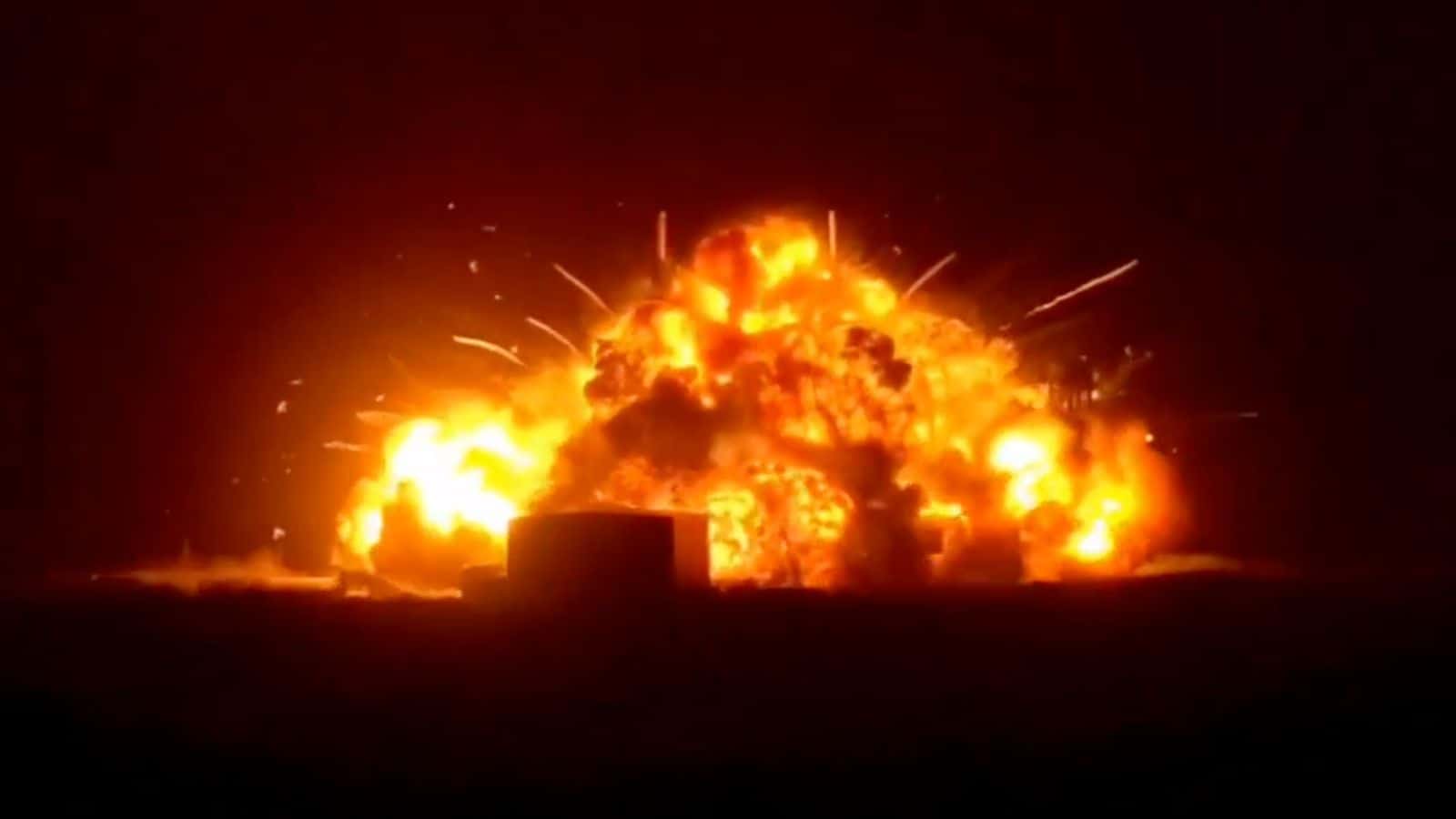 Explosion at night with bright flames and smoke, creating a dramatic scene with fiery destruction and int.