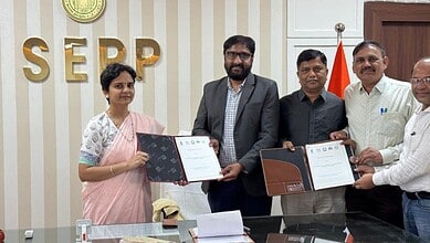 Group of professionals signing documents at SEPP office, India.