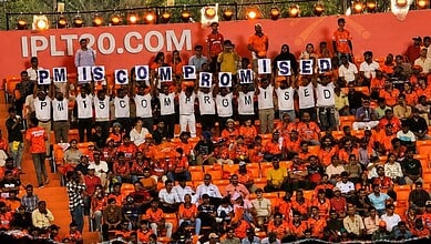 Protesters display signs reading "PM IS COMMITTED" at a political rally, highlighting public support and.