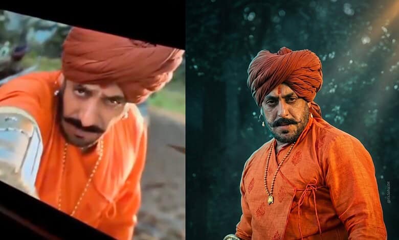 A man dressed as Shivaji in traditional orange attire and turban, portraying a warrior in a historical fi.
