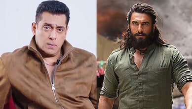 A man with a surprised expression wearing a brown jacket on the left, and a bearded man with long hair in.