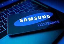 Samsung electronics smartphone on keyboard, highlighting AI-driven growth and chip demand.