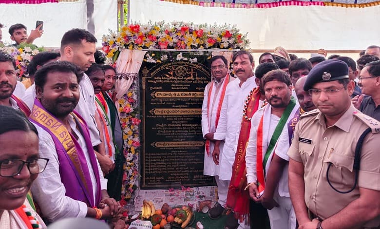 A commemorative event with officials and community members unveiling a plaque at a public gathering.
