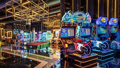 Brightly lit arcade with racing and shooting games, modern decor, and vibrant neon lights at Hyderabad's.