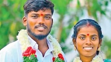 Wedding couple in Telangana, India, dressed in traditional clothes, smiling, with greenery background.