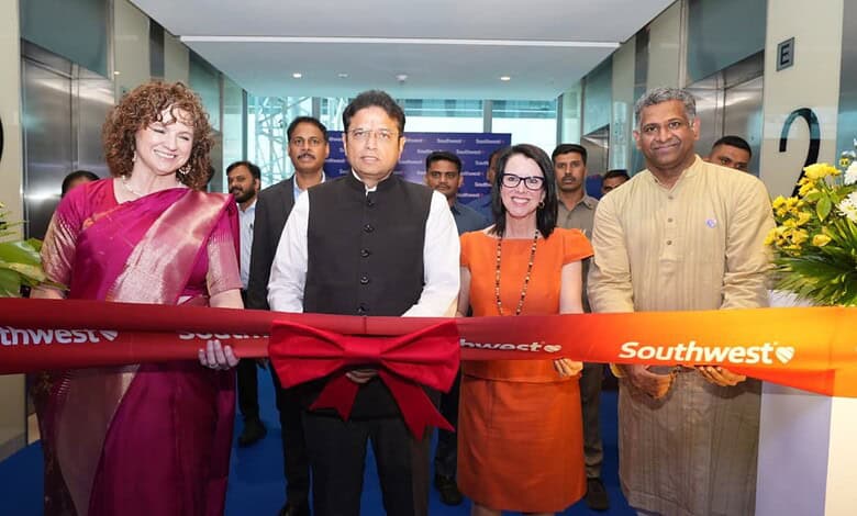 Group of diverse professionals at Southwest Airlines event, ribbon-cutting ceremony in modern airport ter.