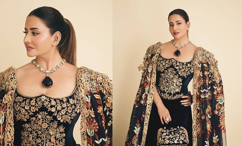 Sudha Reddy in a luxurious black and gold embroidered gown with diamond jewelry at the Met Gala.