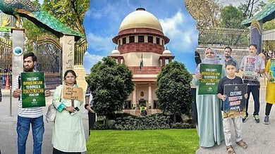 Protesters holding signs outside a government building in India, advocating for environmental and social.