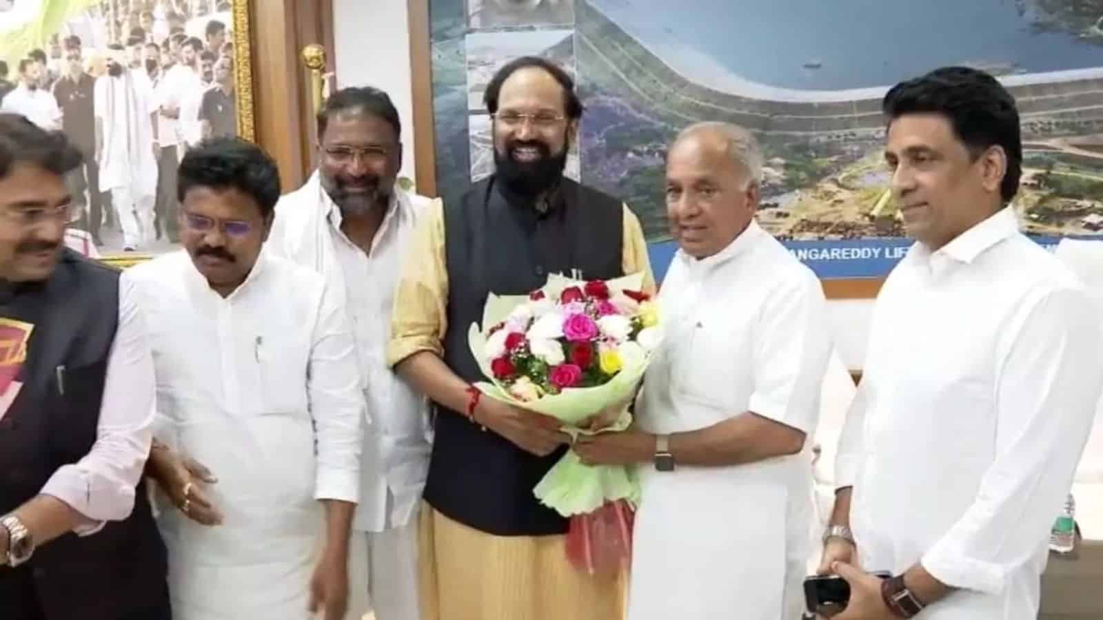 Celebration of a formal event with distinguished guests exchanging flowers and greetings indoors.