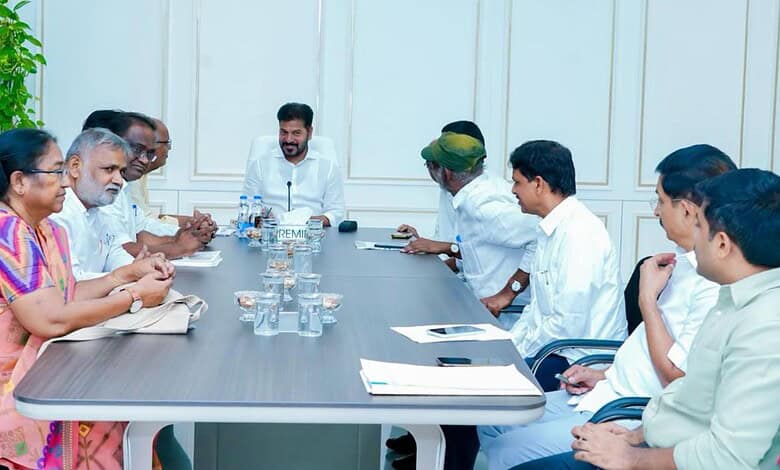 Business meeting with diverse professionals around a conference table in a modern office setting.