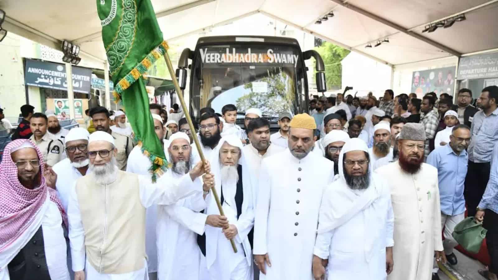 The Siasat Daily: Religious leaders and community members gather around a tractor at a public event.