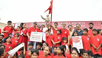 Participants in Hyderabad awareness walk for Thalassaemia Day, holding banners and raising awareness abou.
