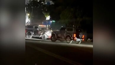 Nighttime scene of a car accident with multiple vehicles on a dark road, emergency response in progress.