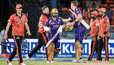 Cricket players celebrating after a match, with team members and officials in a stadium setting.