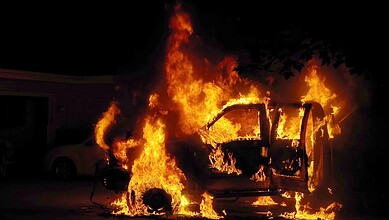 Van on fire after being set ablaze by Hindutva mob in Odisha, driver escapes the scene.