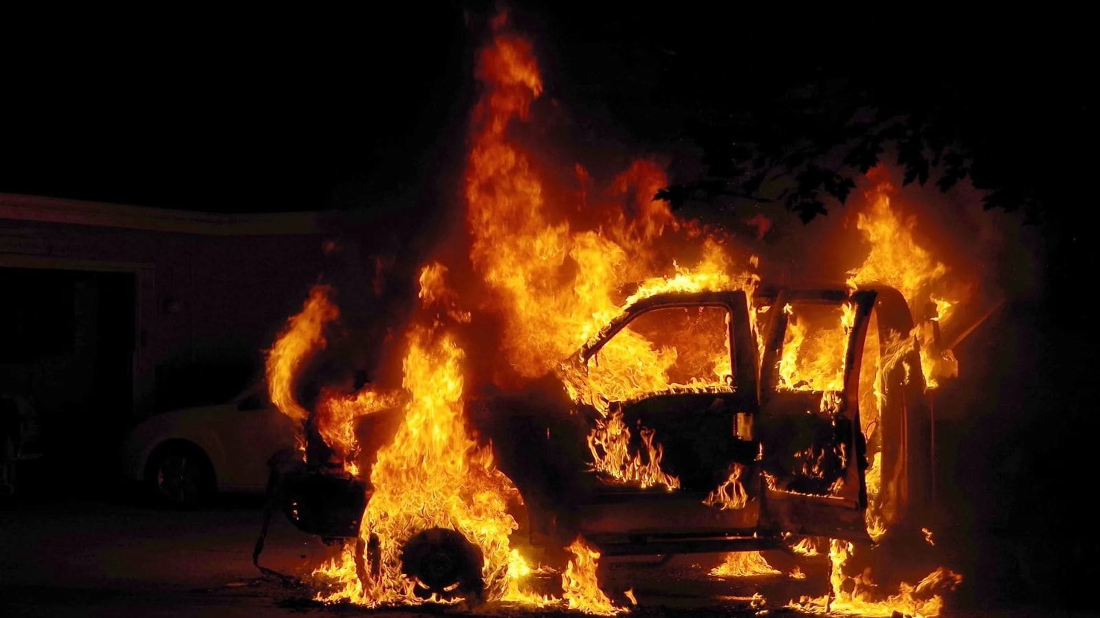 Van on fire after being set ablaze by Hindutva mob in Odisha, driver escapes the scene.