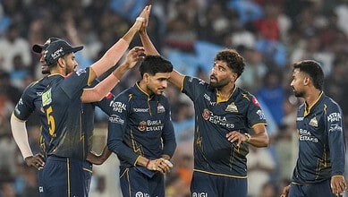 Gujarat Titans players celebrate during the match, showcasing teamwork and sportsmanship in cricket.