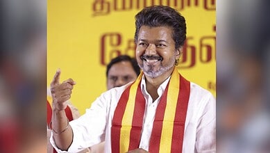 Tamil Nadu politician Vijay's father gestures during a political event, calling for alliance with Congres.