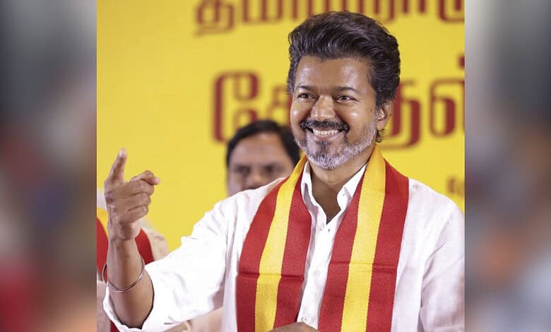 Tamil Nadu politician Vijay's father gestures during a political event, calling for alliance with Congres.