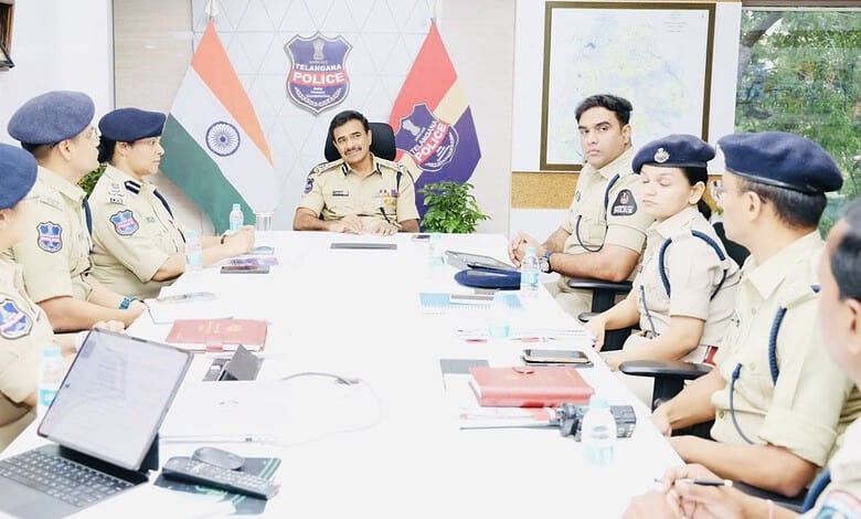 Police officers in uniform attending a meeting in a police station conference room.